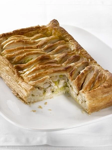 Chicken Jalousie, chicken and leek baked in puff pastry, with a slice cut away, close-up