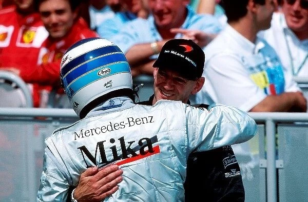 Formula One World Championship: Mika Hakkinen Mclaren MP4-15, 2nd place is greeted by Adrian Newey Mclaren Technical Director