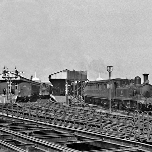 Steam engine and carriages at a coastal station