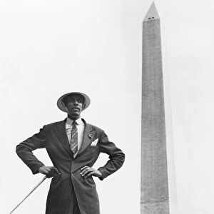 WASHINGTON MONUMENT, c1945. An African American man with helmet and cane, posed