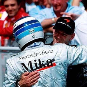 Formula One World Championship: Mika Hakkinen Mclaren MP4-15, 2nd place is greeted by Adrian Newey Mclaren Technical Director