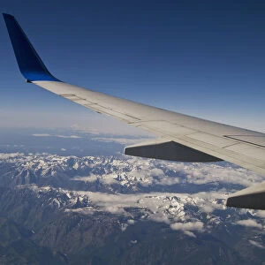 A Commercial Jet Flies Over The Mountains Of The American West; Colorado, United States Of America
